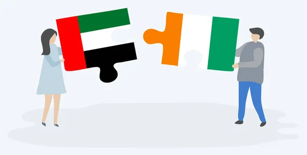 Par Som Innehar Två Pusselbitar Med Emiriska Och Ivorianska Flaggor — Stock vektor