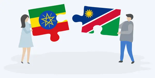 Pareja Sosteniendo Dos Piezas Rompecabezas Con Banderas Etiopía Namibia Etiopía — Vector de stock