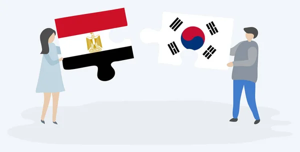 Para Trzyma Dwa Kawałki Puzzli Egipskich Południowokoreańskich Flag Symbole Narodowe — Wektor stockowy