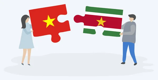 Dvojice Která Drží Dvě Skládanky Vietnamskými Surinamskými Vlajkami Společné Národní — Stockový vektor