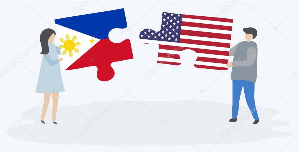 Couple holding two puzzles pieces with Filipino and American flags. Philippines and United States of America national symbols together.