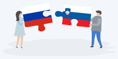 Rus ve Sloven bayrakları ile iki bulmaca parçaları tutan çift. Rusya ve Slovenya ulusal sembolleri bir arada.