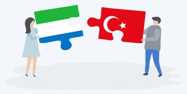 Sierra Leonean ve Türk bayrakları ile iki bulmaca parçaları tutan çift. Sierra Leone ve Türkiye ulusal sembolleri bir arada.