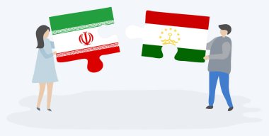 İran ve Tacikistanbayrakları ile iki bulmaca parçaları tutan çift. İran ve Tacikistan ulusal sembolleri birlikte.