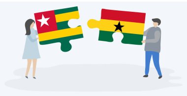 Togolya ve Gana bayraklarıyla iki bulmaca tutan çift. Togo ve Gana ulusal sembolleri birlikte.