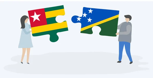Togolese Solomon Island Bayrakları Ile Iki Bulmaca Parçaları Tutan Çift — Stok Vektör