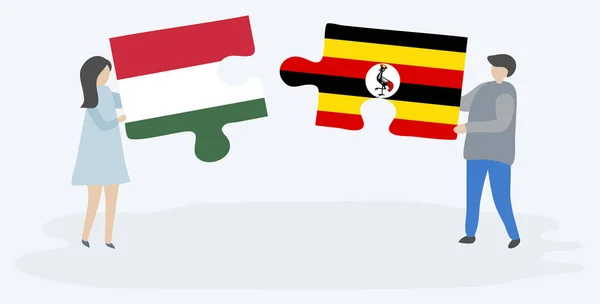 Para Trzyma Dwa Kawałki Puzzli Węgierskimi Ugandy Flagi Symbole Narodowe — Wektor stockowy