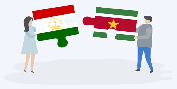 Dvojice Drží Dvě Skládanky Vlajkami Tádžické Surinamse Národní Symboly Tádžikistánu — Stockový vektor