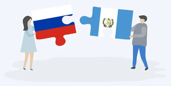 一对夫妇拿着两个拼图片 上面挂着俄罗斯和危地马拉国旗 俄罗斯和危地马拉国家符号在一起 — 图库矢量图片