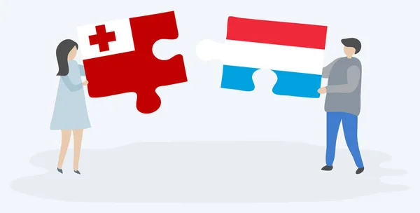 Para Trzyma Dwa Kawałki Puzzli Tongan Luxembourgish Flagi Symbole Narodowe — Wektor stockowy