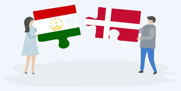 Casal Segurando Duas Peças Quebra Cabeças Com Bandeiras Tajiquistanesas Dinamarquesas —  Vetores de Stock