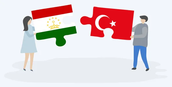 Casal Segurando Dois Quebra Cabeças Peças Com Bandeiras Tajiquistanesas Turcas — Vetor de Stock