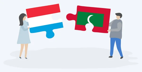 Couple Tenant Deux Pièces Puzzles Avec Des Drapeaux Luxembourgeois Maldiviens — Image vectorielle