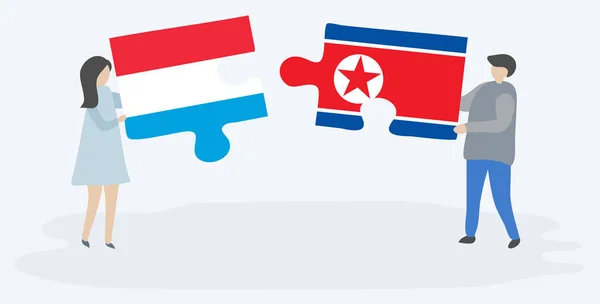 Pár Jich Drží Dva Skládanky Lucemburskou Severokorejskou Vlajkou Lucembursko Severní — Stockový vektor