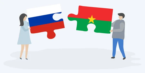 Casal Segurando Duas Peças Quebra Cabeças Com Bandeiras Russas Burkinabe —  Vetores de Stock
