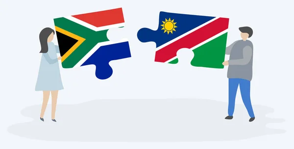 南アフリカとナミビアの旗を持つ2つのパズルピースを保持しているカップル 南アフリカとナミビアの国のシンボル — ストックベクタ