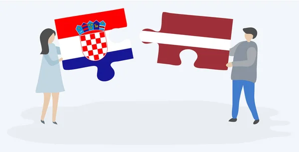 Casal Segurando Duas Peças Quebra Cabeças Com Bandeiras Croatas Letãs — Vetor de Stock