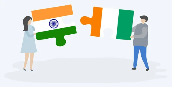 インドとアイボリアンの旗を持つ2つのパズルのピースを保持しているカップル インドとコートジボワールの国のシンボル — ストックベクタ