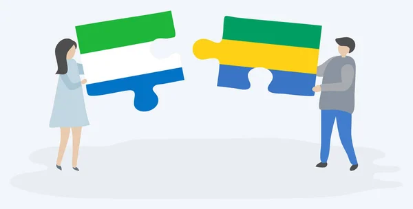 Dvojice Drží Dvě Skládanky Vlajkami Sierra Leonean Gabonu Národní Symboly — Stockový vektor