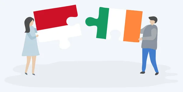 Para Trzyma Dwa Kawałki Puzzli Indonezyjskich Irlandzkich Flag Symbole Narodowe — Wektor stockowy