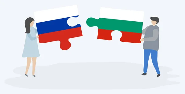 一对夫妇拿着两个拼图 上面挂着俄罗斯和保加利亚国旗 俄罗斯和保加利亚国家符号在一起 — 图库矢量图片