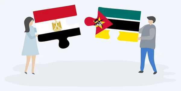 Couple Tenant Deux Pièces Puzzles Avec Des Drapeaux Égyptiens Mozambicains — Image vectorielle