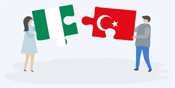 一对夫妇拿着两块拼图 上面挂着尼日利亚和土耳其国旗 尼日利亚和土耳其国家符号在一起 — 图库矢量图片