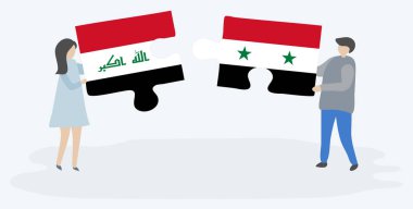 Irak ve Suriye bayrakları yla iki bulmaca tutan çift. Irak ve Suriye ulusal sembolleri bir arada.