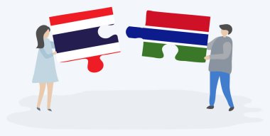 Tay ve Gambiya bayrakları ile iki bulmaca parçaları tutan çift. Tayland ve Gambiya ulusal sembolleri birlikte.