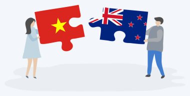 Vietnam ve Nz bayrakları ile iki bulmaca parçaları tutan çift. Vietnam ve Yeni Zelanda ulusal sembolleri birlikte.