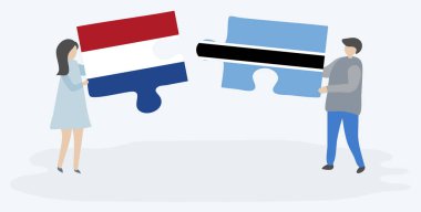 Hollanda ve Motswana bayrakları ile iki bulmaca parçaları tutan çift. Hollanda ve Botsvana ulusal sembolleri birlikte.