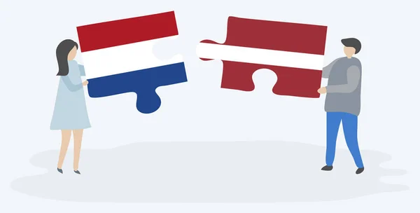 Paar Houden Twee Puzzels Stukken Met Nederlandse Letse Vlaggen Nationale — Stockvector