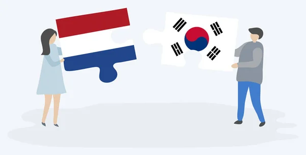 Para Trzyma Dwa Kawałki Puzzli Holenderskimi Południowokoreańskich Flag Symbole Narodowe — Wektor stockowy