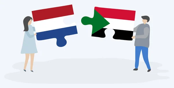 Hollanda Sudan Bayrakları Ile Iki Bulmaca Parçaları Tutan Çift Hollanda — Stok Vektör
