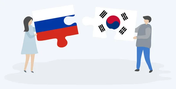 Para Trzyma Dwa Kawałki Puzzli Rosyjskimi Południowokoreańskich Flag Symbole Narodowe — Wektor stockowy