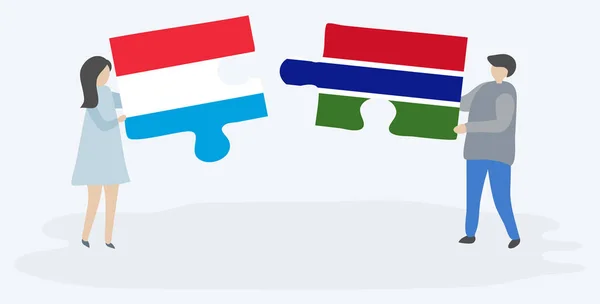 Para Trzyma Dwa Kawałki Puzzli Luksemburskim Gambijskim Flagami Symbole Narodowe — Wektor stockowy