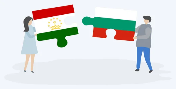 Para Trzyma Dwa Kawałki Puzzli Tajikistani Bułgarskich Flag Tadżykistan Bułgaria — Wektor stockowy
