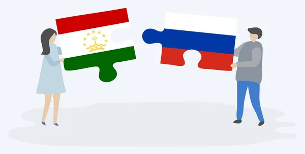 Para Trzyma Dwa Kawałki Puzzle Tadżycki Rosyjskich Flag Tadżykistan Rosja — Wektor stockowy