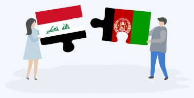 Irak ve Afgan bayrakları yla iki bulmaca tutan çift. Irak ve Afganistan ulusal sembolleri birlikte.