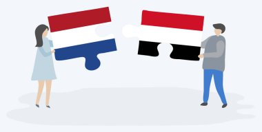 Hollanda ve Yemen bayrakları ile iki bulmaca parçaları tutan çift. Hollanda ve Yemen ulusal sembolleri birlikte.