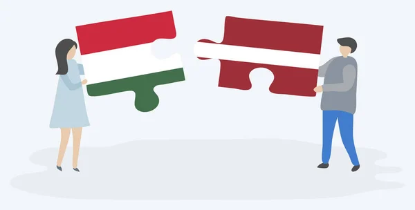 夫妇拿着两个拼图与匈牙利和拉脱维亚国旗 匈牙利和拉脱维亚国家符号在一起 — 图库矢量图片