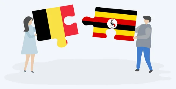 Para Trzyma Dwa Puzzle Kawałki Belgijskich Ugandy Flagi Symbole Narodowe — Wektor stockowy