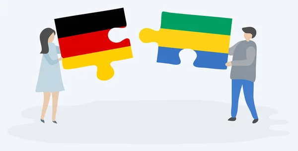 Para Trzyma Dwa Kawałki Puzzli Niemieckim Gabońskim Flagi Symbole Narodowe — Wektor stockowy