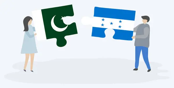 Casal Segurando Duas Peças Quebra Cabeças Com Bandeiras Paquistanesas Hondurenhas — Vetor de Stock
