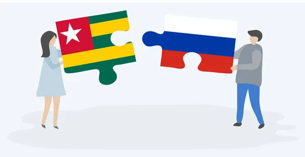 Paar Mit Zwei Puzzleteilen Mit Togolesischen Und Russischen Flaggen Nationalsymbole — Stockvektor