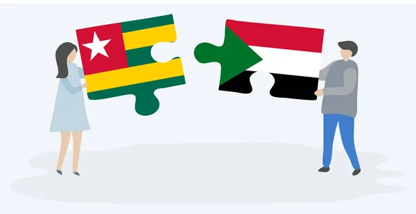 一对夫妇拿着两块拼图 上面挂着多哥和苏丹国旗 多哥和苏丹国家符号在一起 — 图库矢量图片