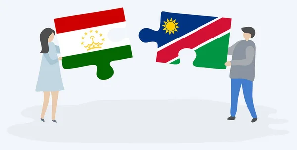 Pareja Sosteniendo Dos Piezas Rompecabezas Con Banderas Tayikistán Namibia Tayikistán — Vector de stock