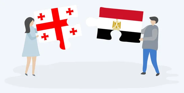 一对夫妇拿着两块拼图 上面挂着格鲁吉亚和埃及国旗 格鲁吉亚和埃及国家符号在一起 — 图库矢量图片