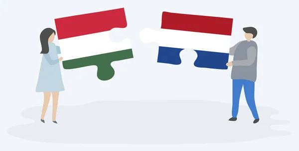 ハンガリーとオランダの旗を持つ2つのパズルのピースを保持しているカップル ハンガリーとオランダのシンボル — ストックベクタ