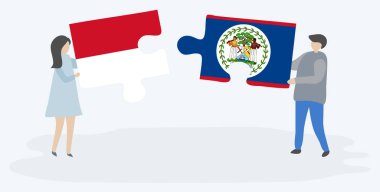Monegasque ve Belizean bayrakları ile iki bulmaca parçaları tutan çift. Monako ve Belize ulusal sembolleri birlikte.